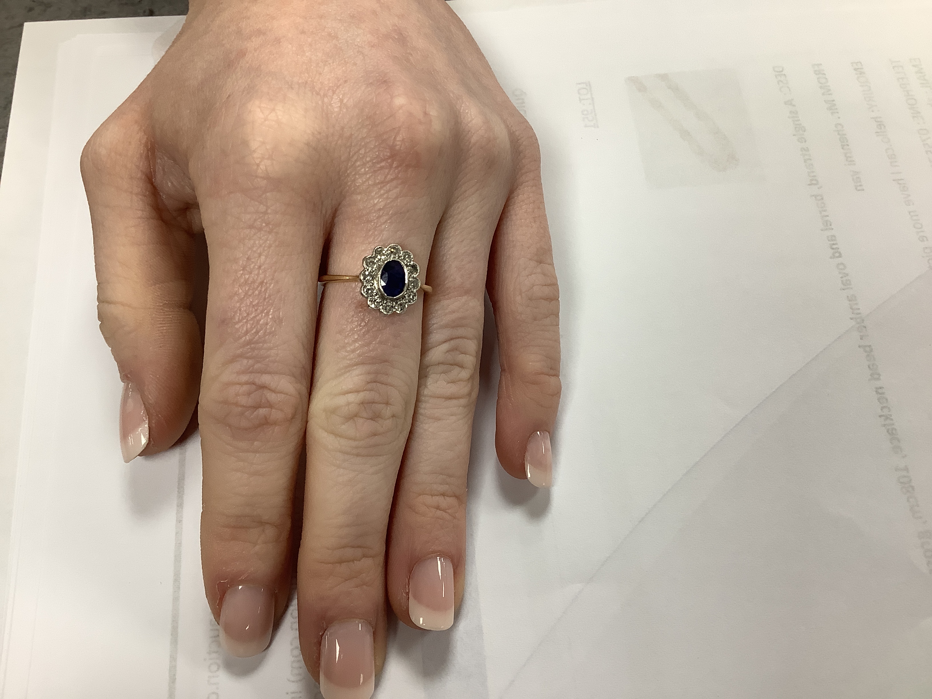 An early to mid 20th century 18ct and plat. sapphire and diamond set oval cluster ring, size L, gross weight 2.5 grams.